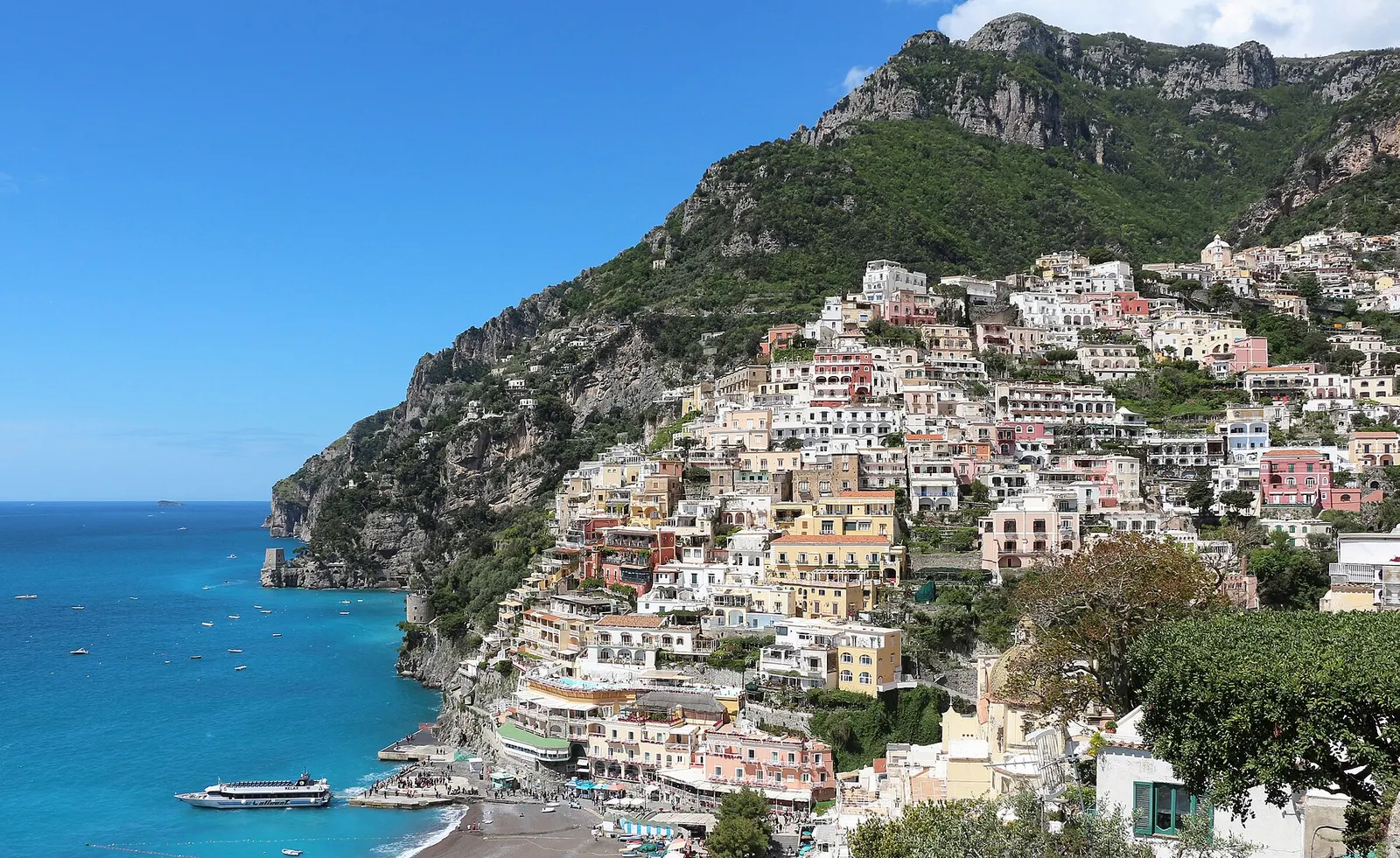 Pastelkleurige huizen van Positano tegen de heuvels van de Amalfikust
